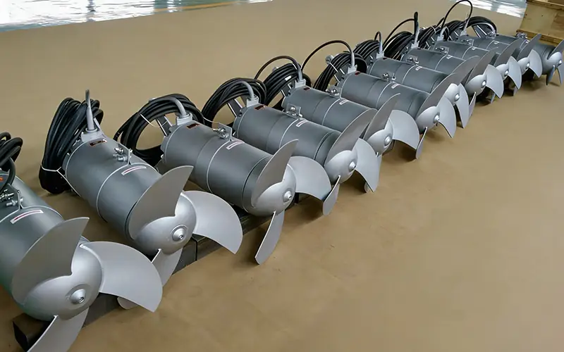Batch of submersible mixers ready for delivery, featuring 3-blade stainless steel impellers for wastewater mixing applications.