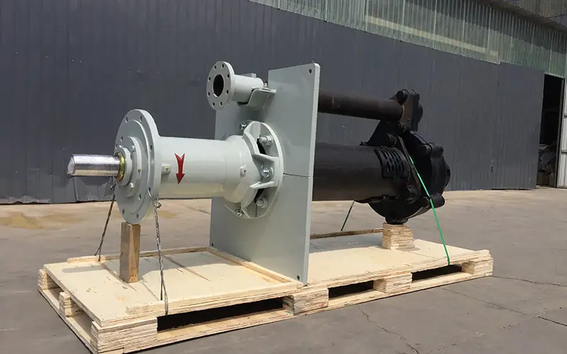 Vertical slurry pump with long shaft, mounted on wooden pallet, with red flow direction arrow-1