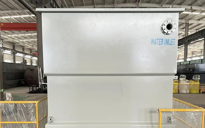 Wastewater treatment plant component with clearly marked "WATER INLET" port, for modular sewage treatment systems.