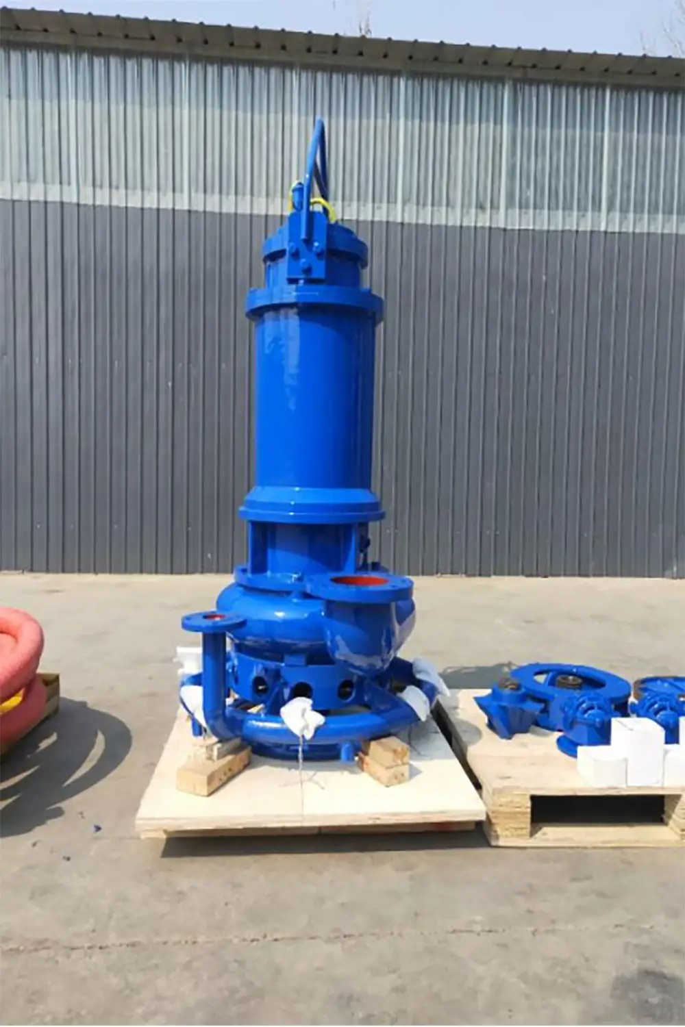 blue submersible sewage pump on a wooden pallet for industrial wastewater applications