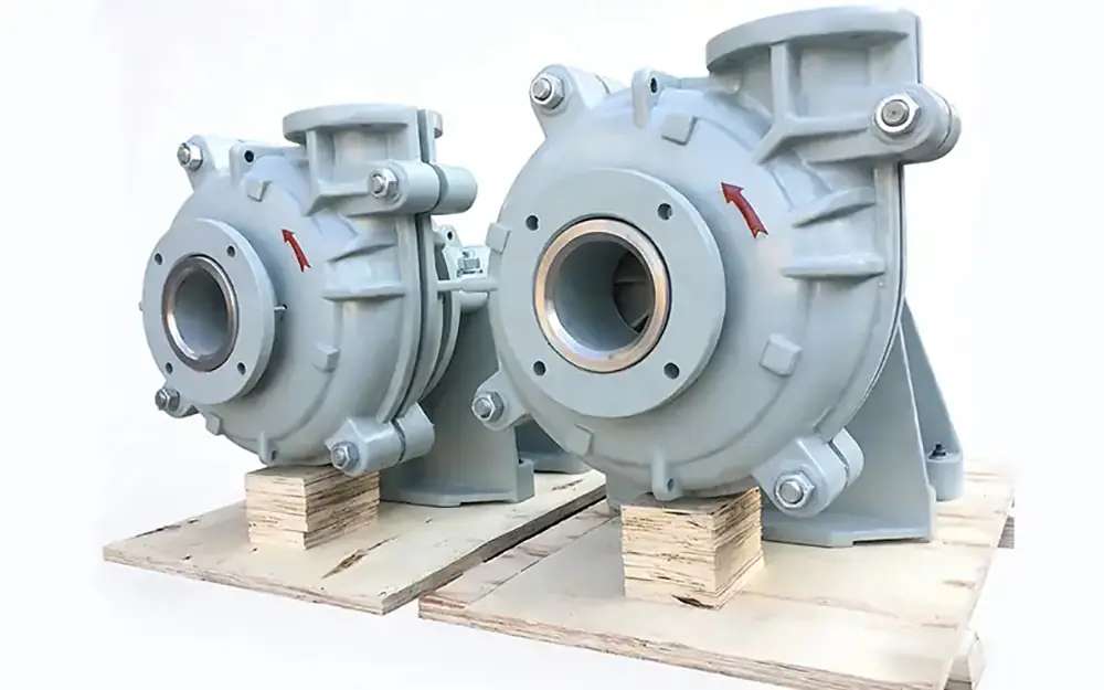 Two horizontal slurry pumps with heavy-duty casings and large inlet ports, shown mounted on wooden pallets.