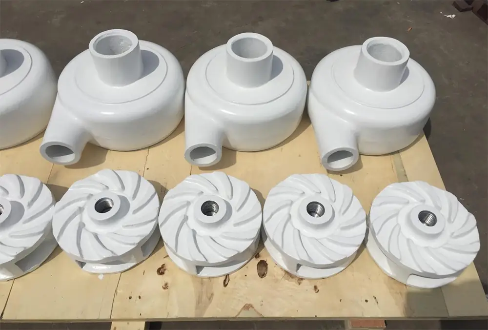 white centrifugal pump casings and matching closed impellers neatly arranged on a wooden pallet