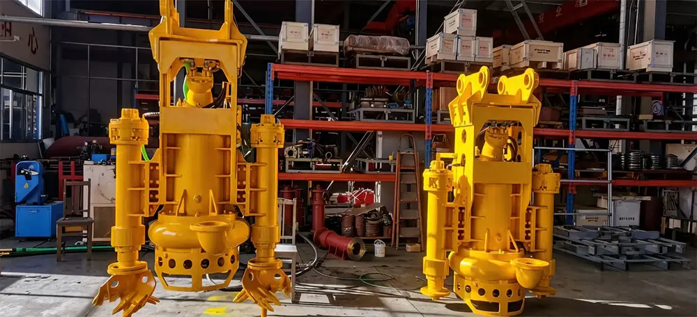 Yellow submersible slurry pumps with agitators displayed in an industrial workshop